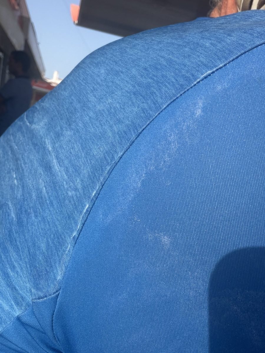 Close-up of a blue cycling jersey streaked with white dried salt