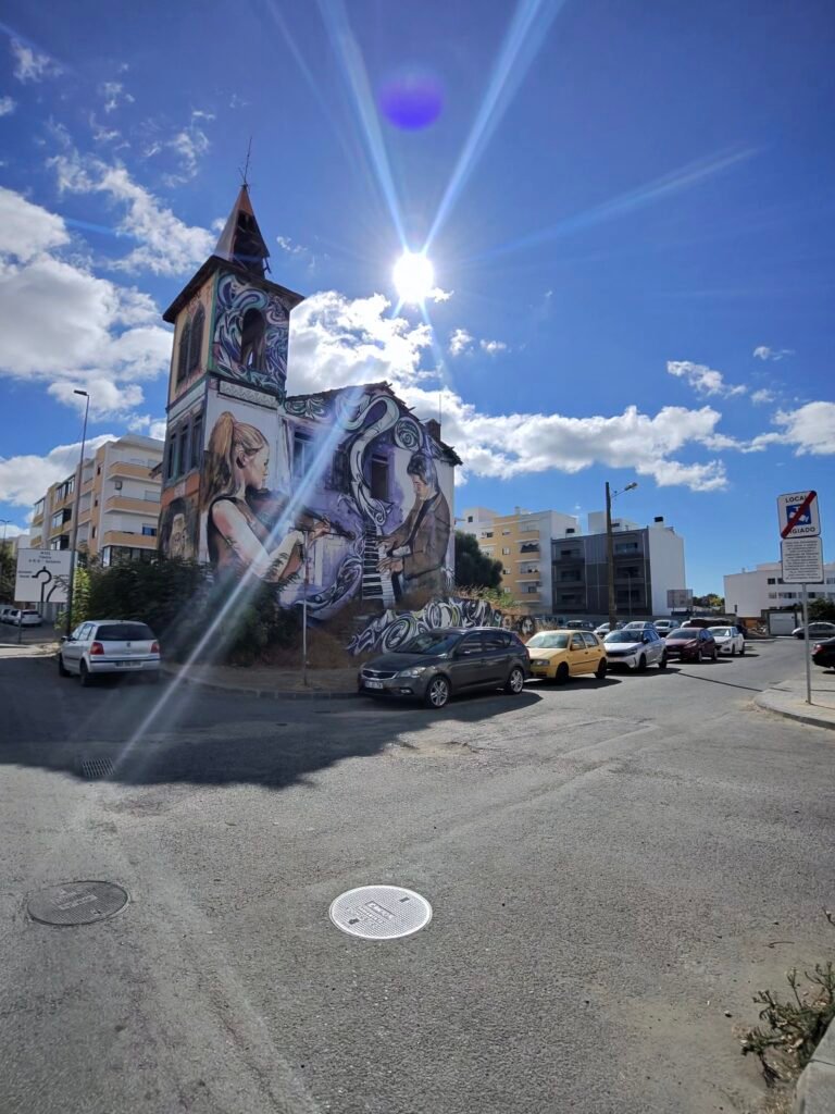 A towered house in Olhão covered in large painted murals